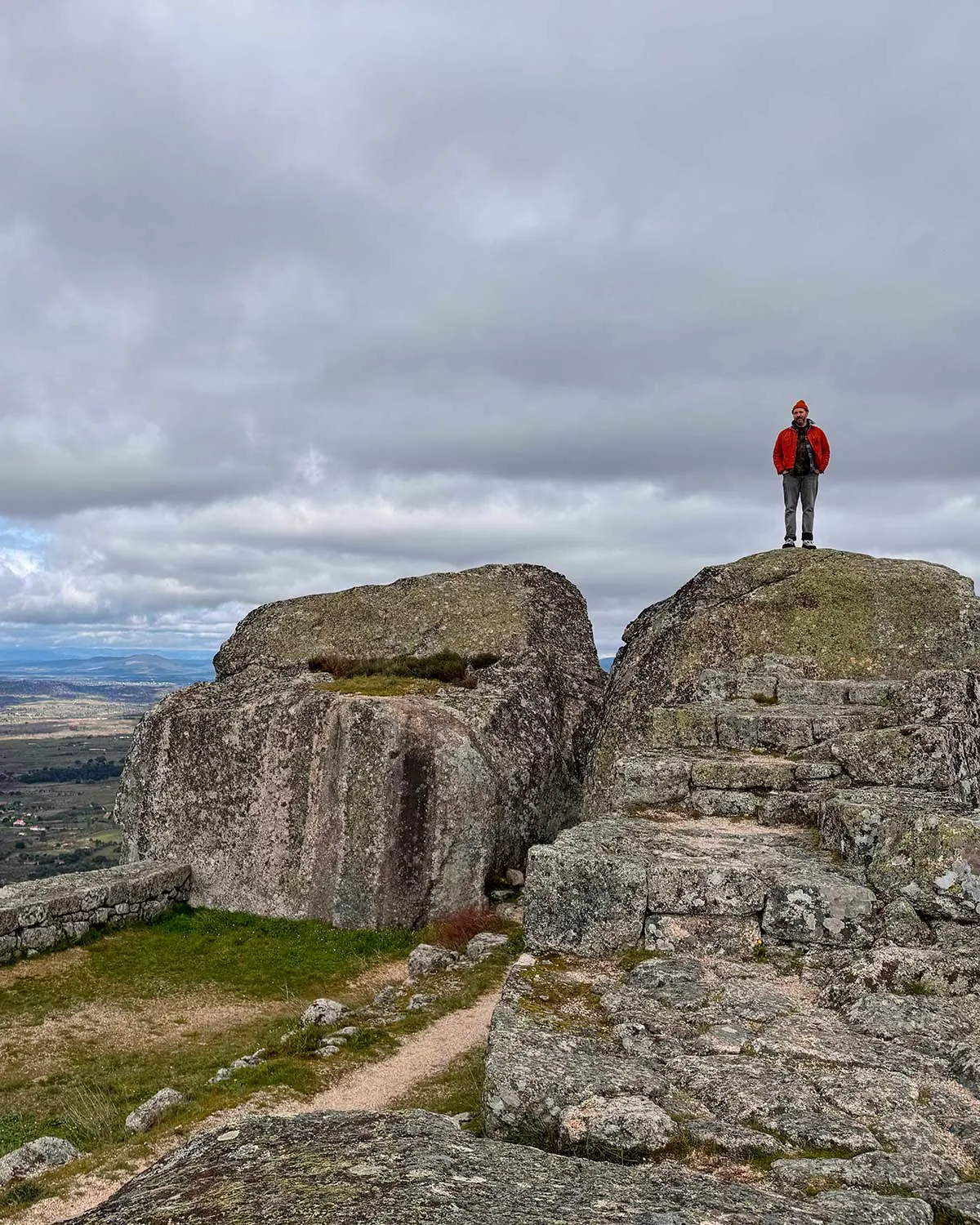 Danny standing on a rock outcropping overlooking the Portuguese countryside